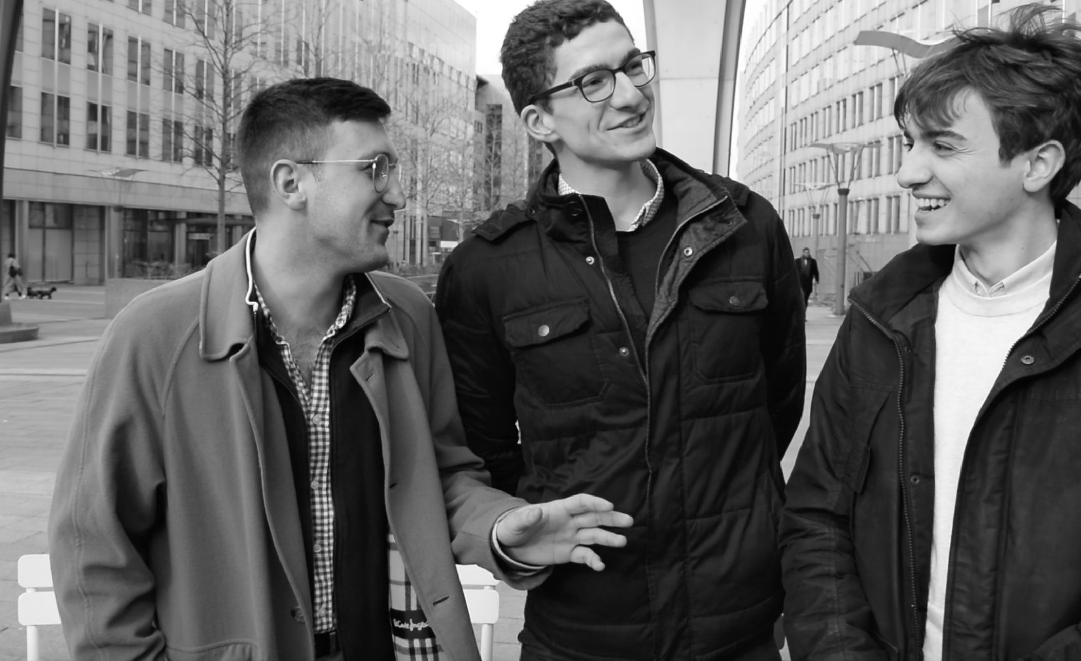 The three initiators of the ECI (Timo, Tassos and Sandro) are pictured while talking to each other in a street.
